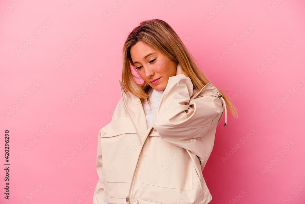 Young mixed race woman isolated on pink background having a neck pain due to stress, massaging and touching it with hand. Young mixed race woman isolated on pink background having a neck pain due to stress, massaging and touching it with hand.
