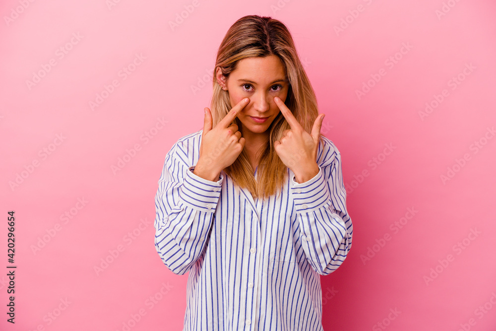Young mixed race woman isolated on pink background crying, unhappy with something, agony and confusion concept. Young mixed race woman isolated on pink background crying, unhappy with something, agony and confusion concept.