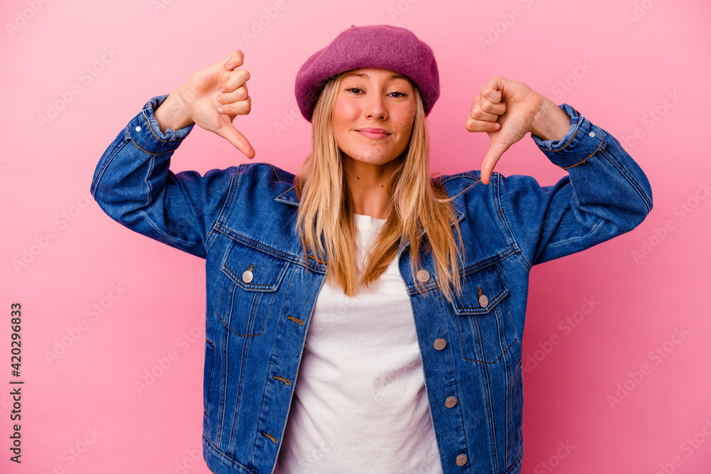 Young mixed race woman isolated on pink background feels proud and self confident, example to follow. Young mixed race woman isolated on pink background feels proud and self confident, example to follow.