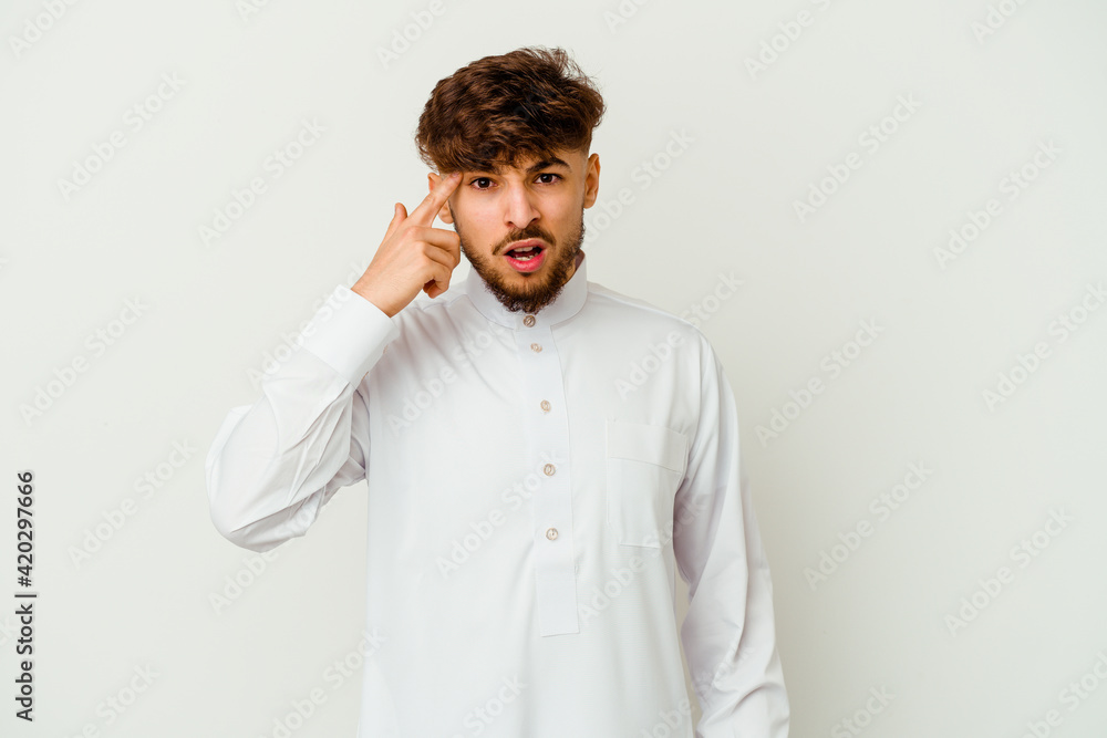 Young Moroccan man wearing a typical arab clothes isolated on white background showing a disappointment gesture with forefinger. Young Moroccan man wearing a typical arab clothes isolated on white background showing a disappointment gesture with forefinger.