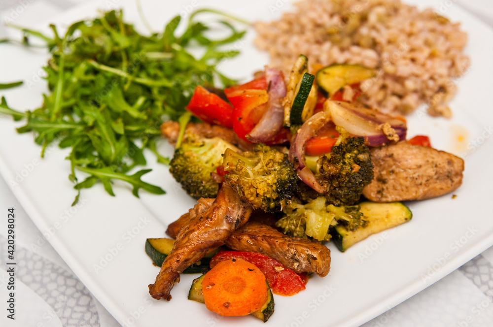 Fototapeta premium Fried chicken stripes with vegetables dish