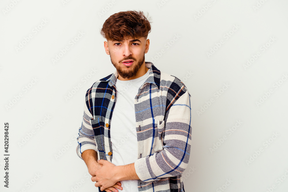 Young Moroccan man isolated on white background having a liver pain, stomach ache. Young Moroccan man isolated on white background having a liver pain, stomach ache.