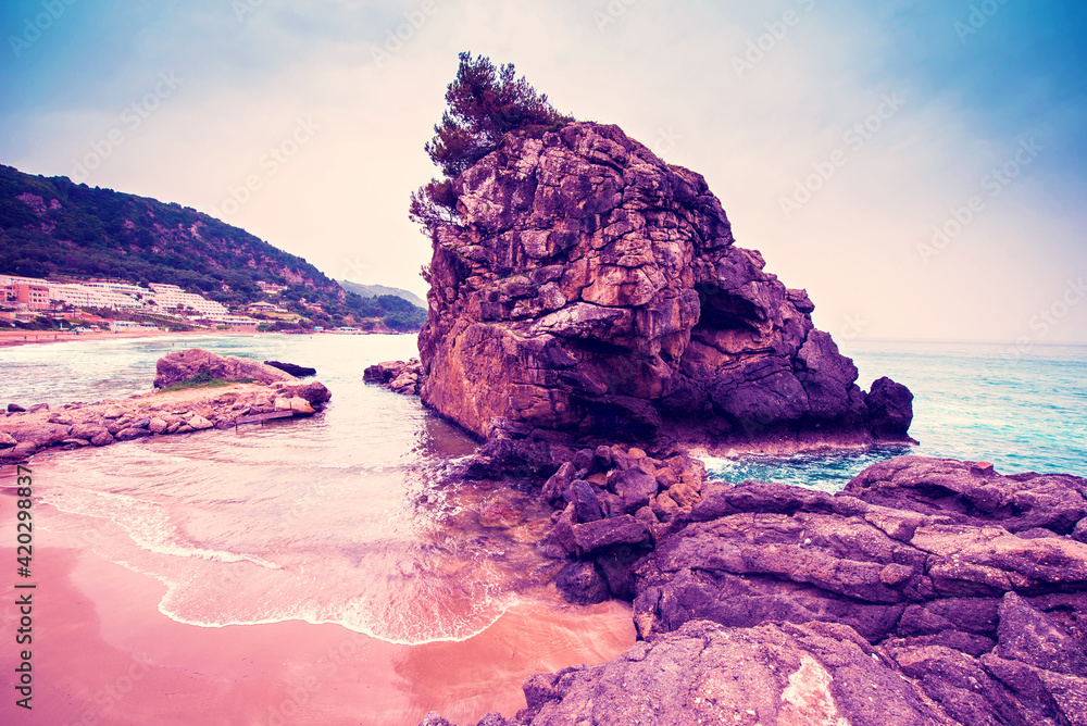 Beautiful magical landscape with a cliff face in the middle of the sea on Pelekas beach on Ionian Sea in Corfu, Greece. amazing places. popular tourist atraction. dramatic scene.