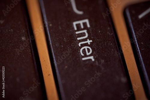 The button of an old laptop. Key Enter. Macro effect photo.