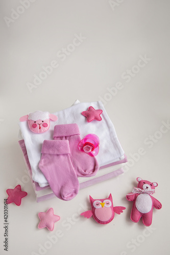 infant baby clothes baby girl pacifier cap on background