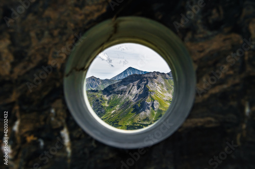 View Through Hole In Wall To High Alpine Landscape With Mountains In National Park Hohe Tauern In Austria