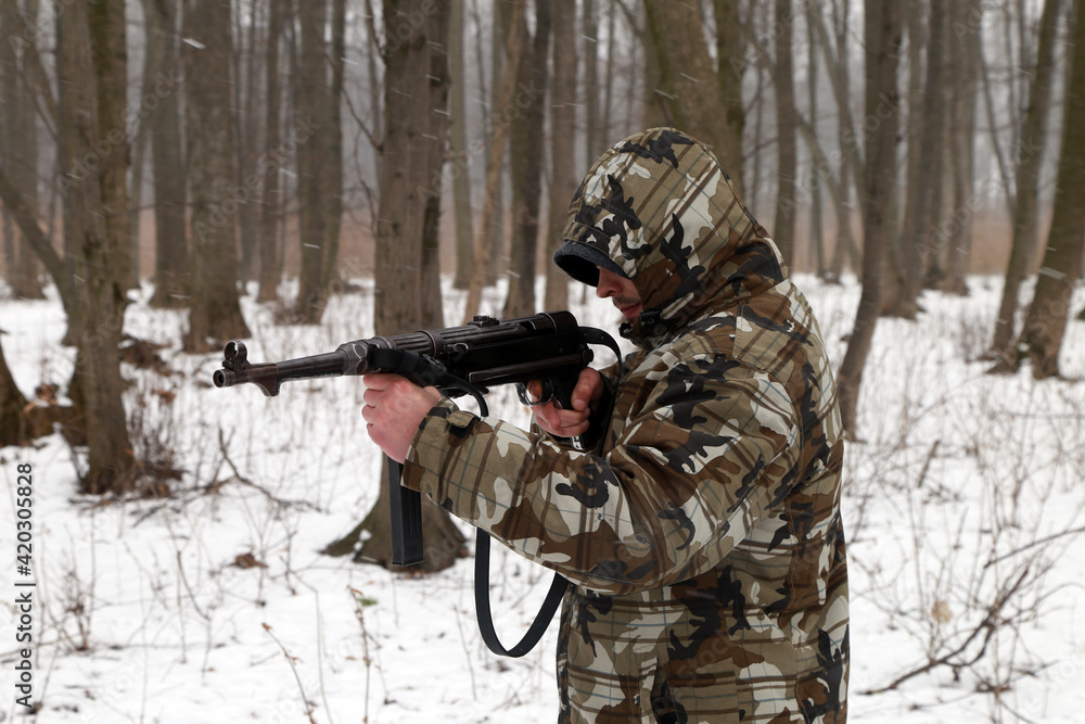 A soldier with german machine gun in the forest