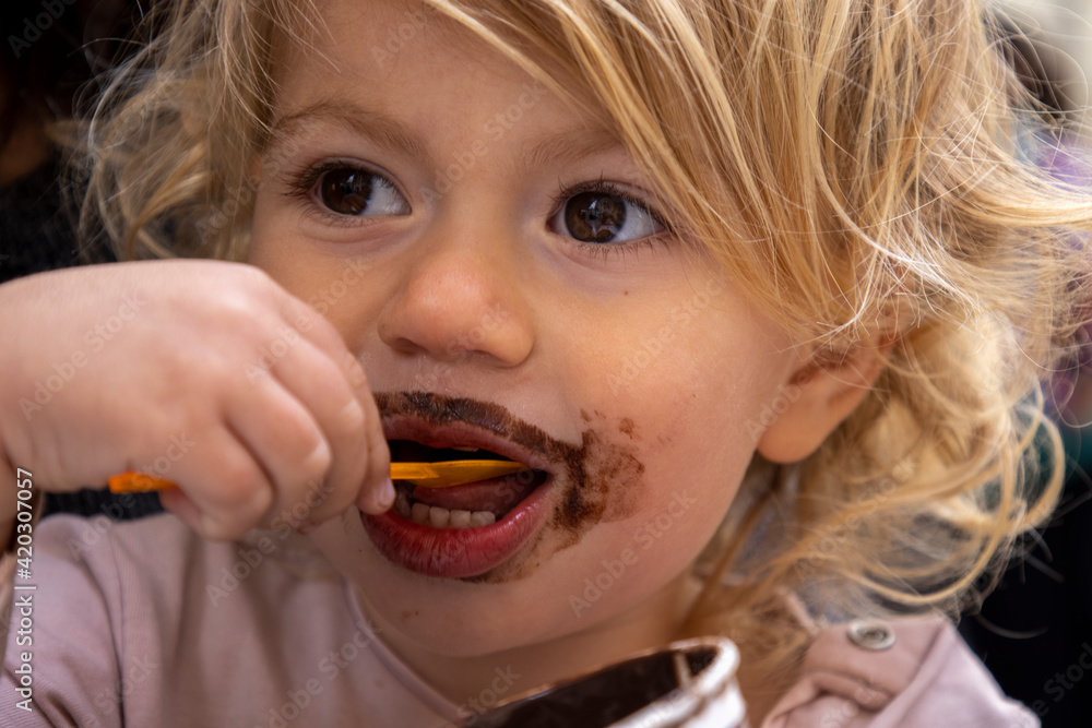 Baby girl eating chocolate icecream Baby girl eating chocolate icecream