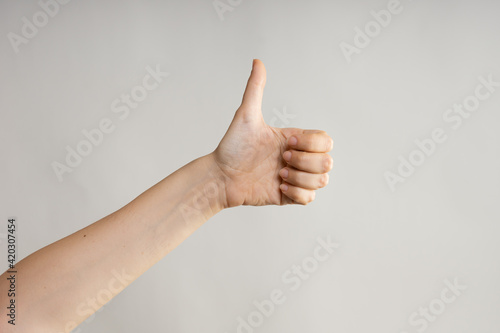 Hand gestures, Thumbs up, like approval. women's hand