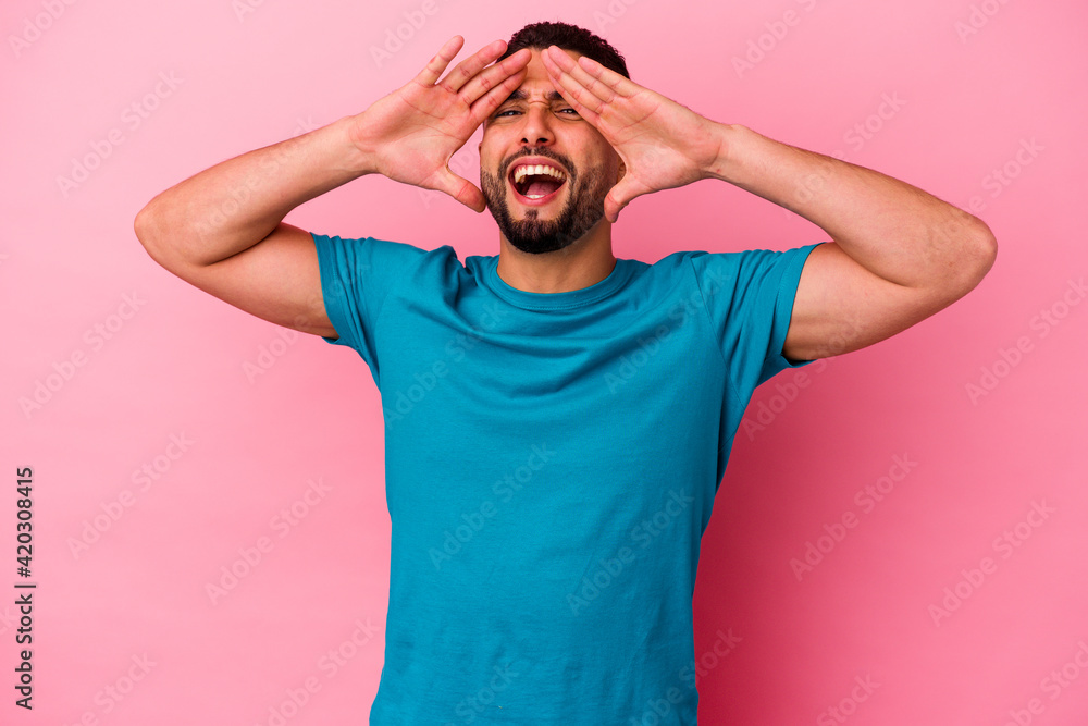 Young mixed race man isolated on pink background Young mixed race man isolated on pink background