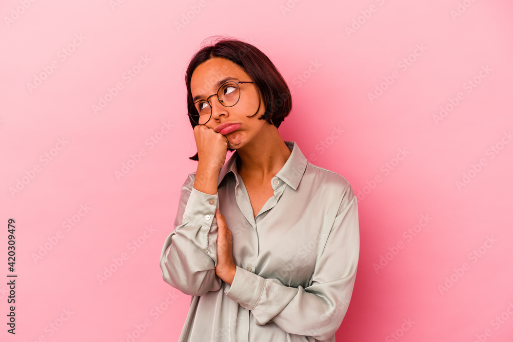 Young mixed race woman isolated on pink background tired of a repetitive task. Young mixed race woman isolated on pink background tired of a repetitive task.