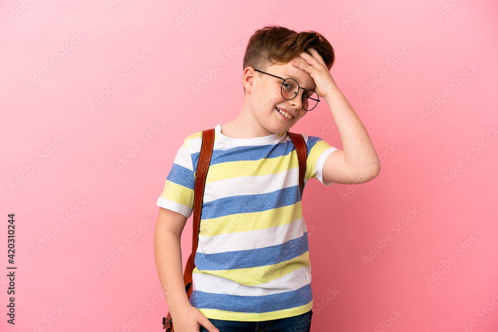 Little redhead caucasian boy isolated on pink background smiling a lot Little redhead caucasian boy isolated on pink background smiling a lot