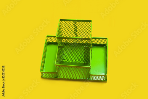 green empty pencil holder isolated on yellow background