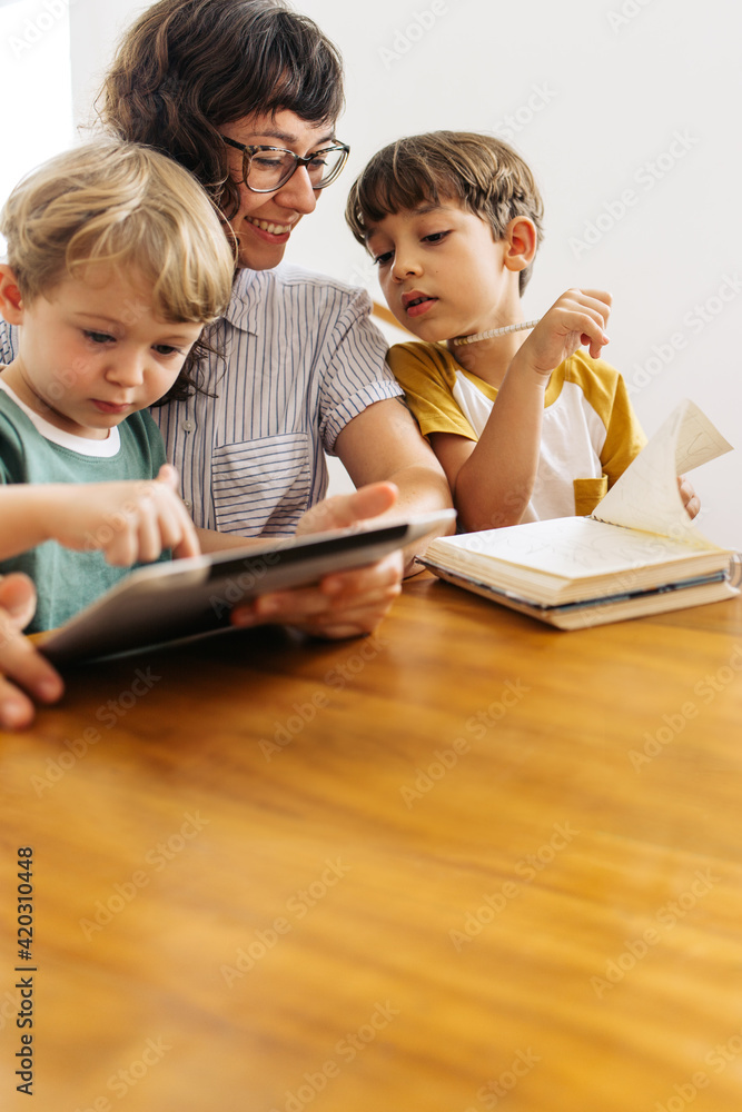 Young family together with a digital tablet