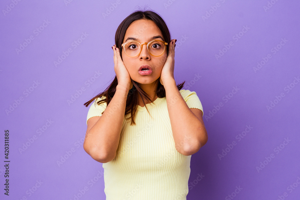 Young mixed race woman isolated covering ears with hands trying not to hear too loud sound. Young mixed race woman isolated covering ears with hands trying not to hear too loud sound.