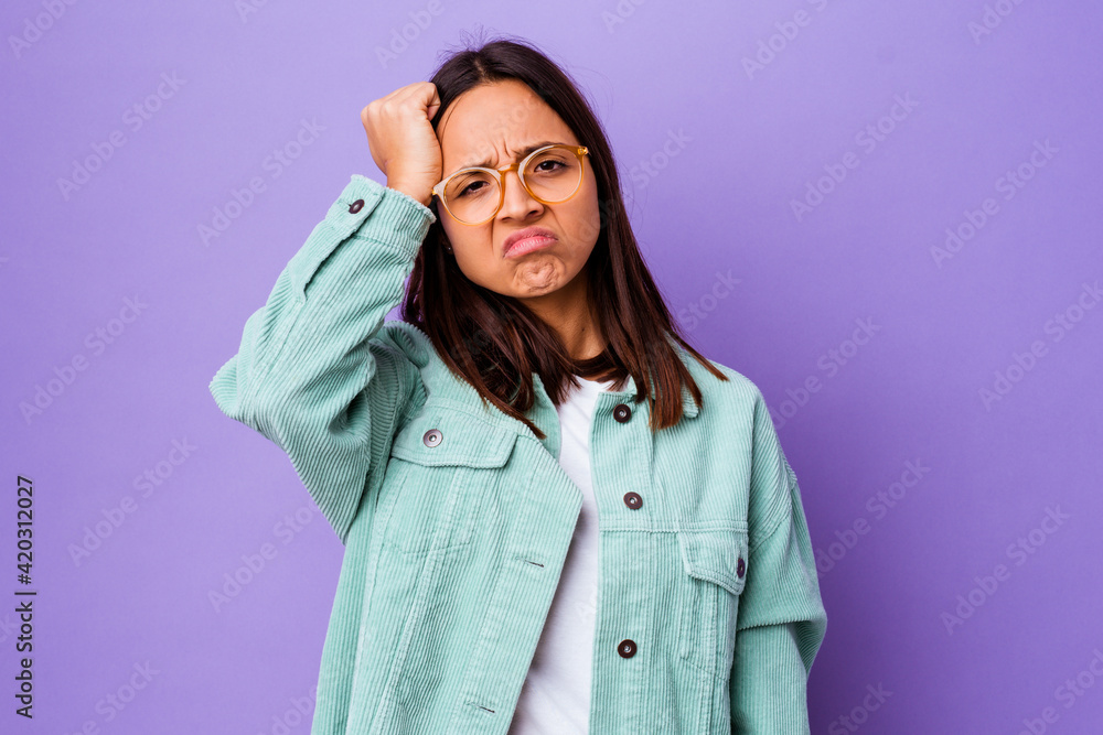 Young mixed race woman isolated tired and very sleepy keeping hand on head. Young mixed race woman isolated tired and very sleepy keeping hand on head.