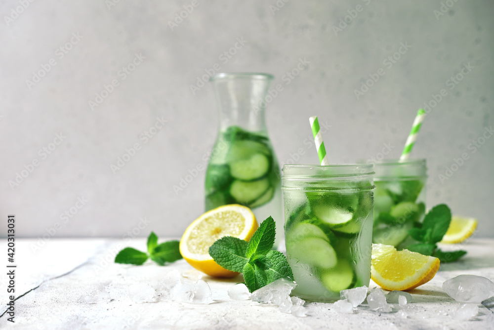 Fototapeta premium Delicious cold summer lemonade with cucumber and mint in a mason jars.