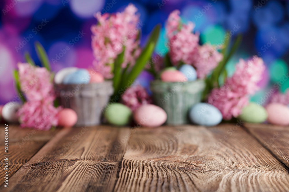 Easter background. Easter eggs and spring flowers. Rustic wooden table. Pastel colors bokeh. Place for typography. Easter background. Easter eggs and spring flowers. Rustic wooden table. Pastel colors bokeh. Place for typography.
