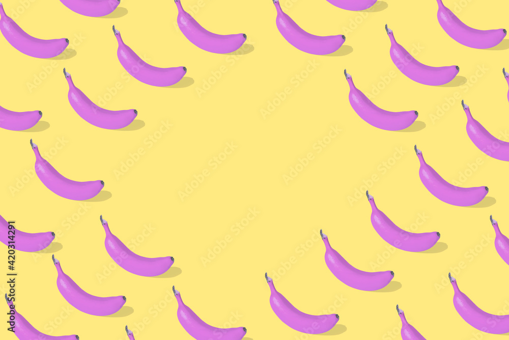 Trendy Summer food pattern made with fresh banana fruit colored in pink on illuminating yellow background. Trendy Summer food pattern made with fresh banana fruit colored in pink on illuminating yellow background.
