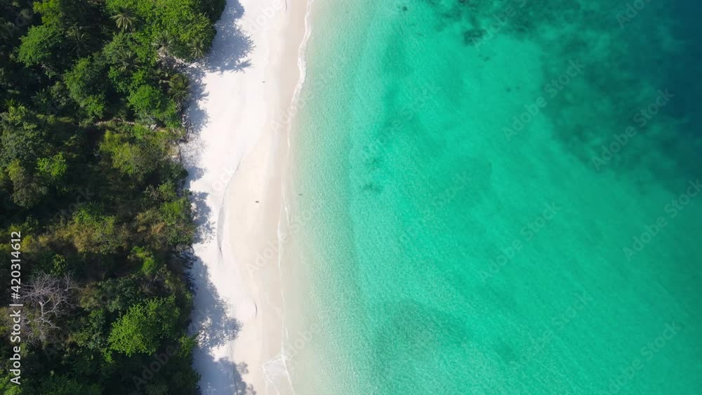 Aerial view shot. Drone camera over white beach sand and sew water clear. Nature video view of beautiful tropical beach and sea in sunny day. Palm tree at beach. At Phuket, Thailand. Aerial view shot. Drone camera over white beach sand and sew water clear. Nature video view of beautiful tropical beach and sea in sunny day. Palm tree at beach. At Phuket, Thailand.