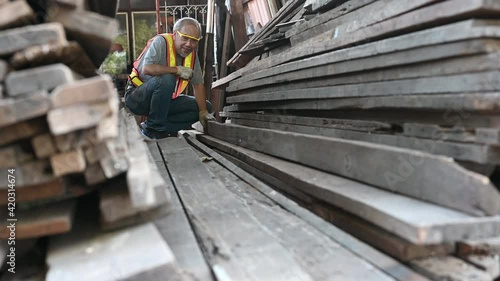 Elderly Asian carpenter working in the carpenter workshop.