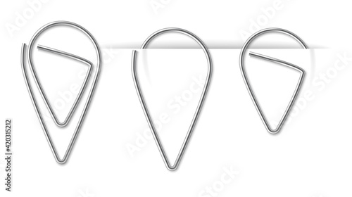 Realistic metal paper clip on white background. Page holders and binders of different shapes