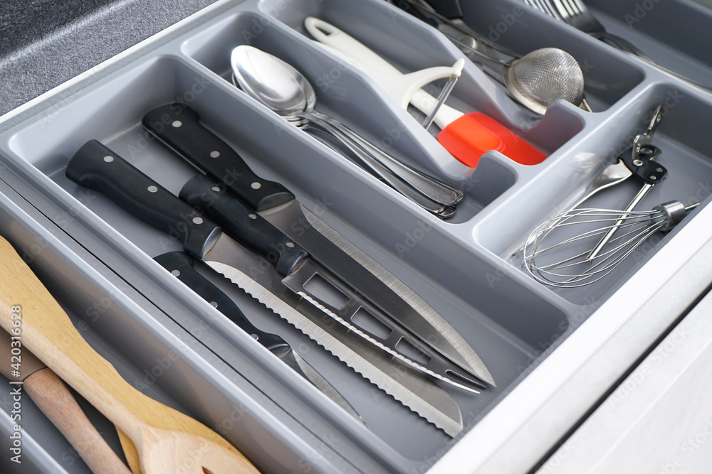 Set of clean kitchen utensils in drawer. Set of clean kitchen utensils in drawer.