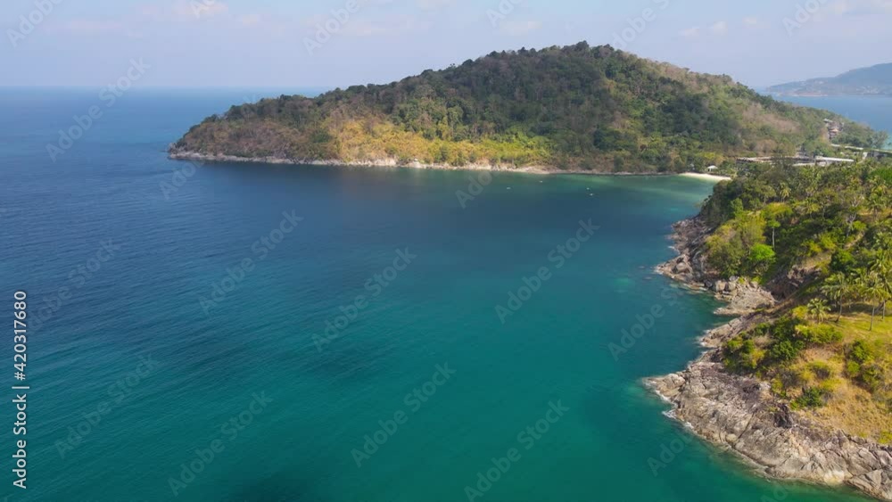 Aerial view shot. Drone camera over white beach sand and sew water clear. Nature video view of beautiful tropical beach and sea in sunny day. Palm tree at beach. At Phuket, Thailand. Aerial view shot. Drone camera over white beach sand and sew water clear. Nature video view of beautiful tropical beach and sea in sunny day. Palm tree at beach. At Phuket, Thailand.