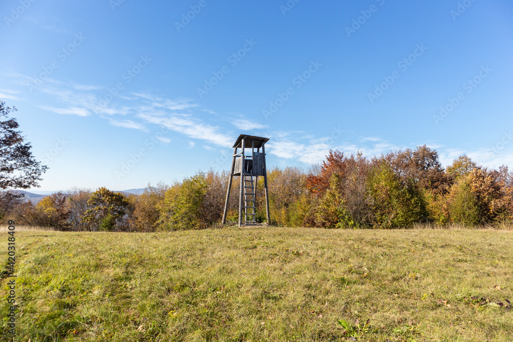 Wooden hunting tower at the clearing in front of the forest on the popular hiking destination of Japetic mountain, Croatia, photographed in autumn season