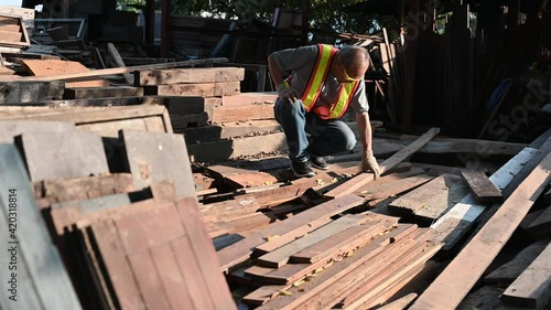 Elderly Asian carpenter working in the carpenter workshop.