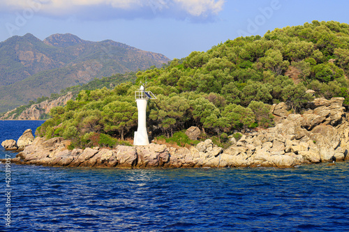 Lighthouse on a stone road in the middle of sea with views of mountains, Bodrum Turkey © rospoint