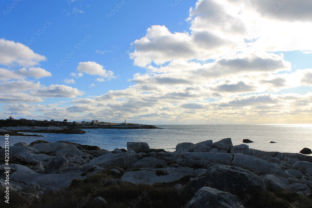 Looking along the rocky coastline toward Peggy's Cove, Nova Scotia, and the Peggy's Cove lighthouse.