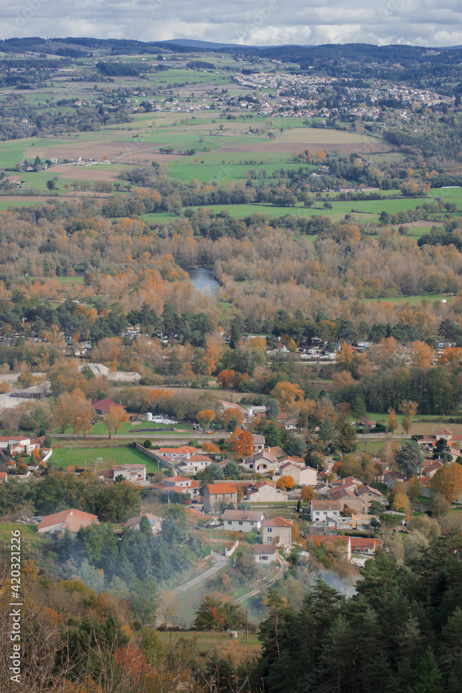 Panoramic view over small french village, surrounded by the nature. Autumn panorama. Reflection of trees in the water