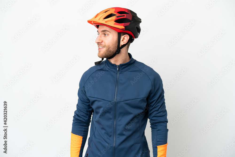 Young cyclist man isolated on white background looking side Young cyclist man isolated on white background looking side