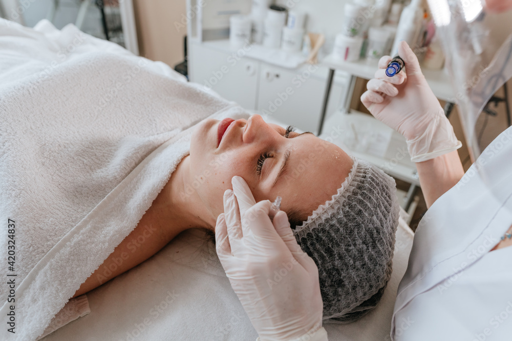 Close-up of an esthetician making facial cleansing procedure Close-up of an esthetician making facial cleansing procedure