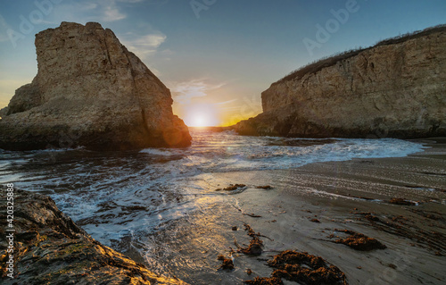 A picturesque sunset in Shark Fin cove, ocean, rocks, beautiful sky. Santa Cruz and Davenport have some of the most beautiful beaches in California.