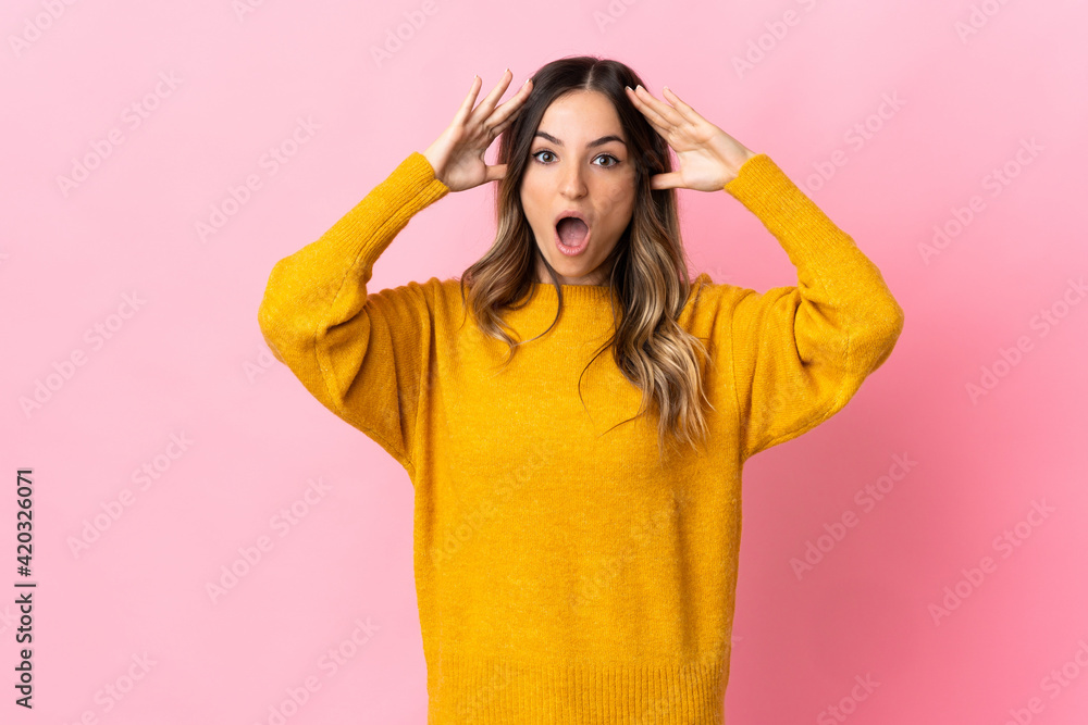 Young Romanian woman isolated on pink background with surprise expression Young Romanian woman isolated on pink background with surprise expression