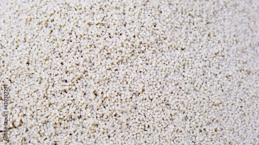 Secondary granule made of polypropylene, White Plastic pellets crumbles. Plastic raw materials in granules for industry. Polymer resin. Raw plastic recycling concept Secondary granule made of polypropylene, White Plastic pellets crumbles. Plastic raw materials in granules for industry. Polymer resin. Raw plastic recycling concept