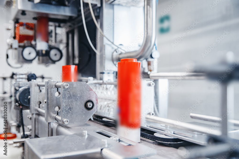 Dairy production, bottle of yoghurt on automated conveyor line, process of milk filling and packaging Dairy production, bottle of yoghurt on automated conveyor line, process of milk filling and packaging