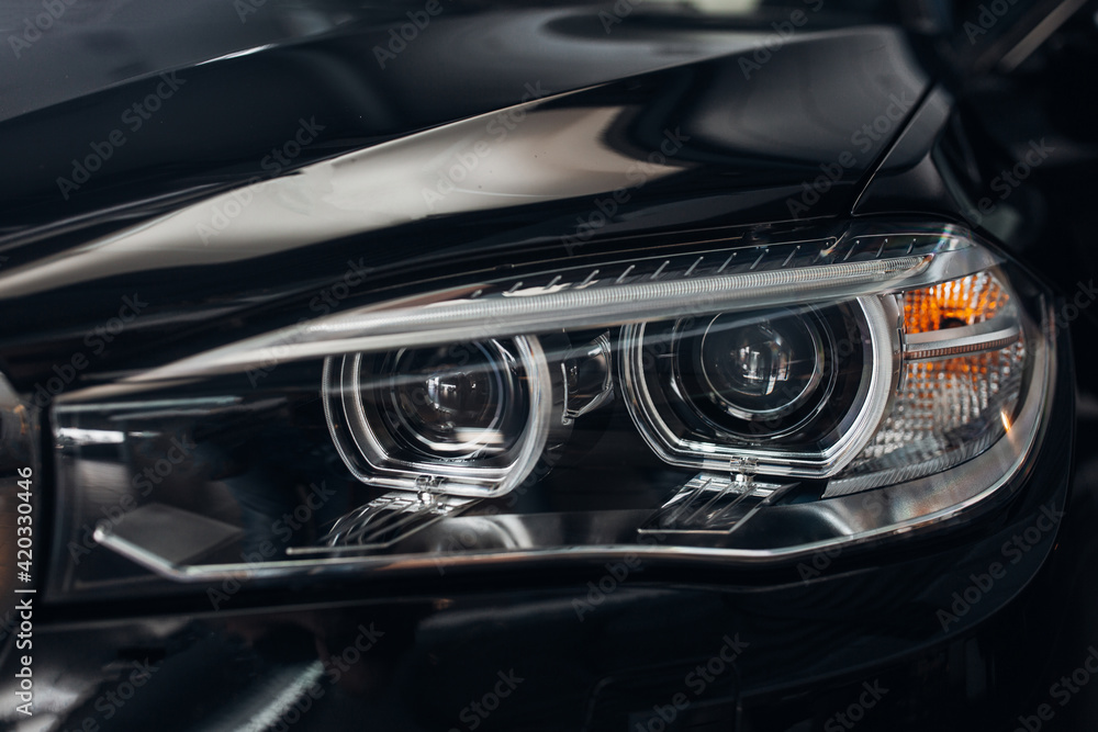 The headlight of modern luxury car. Close up detail shot