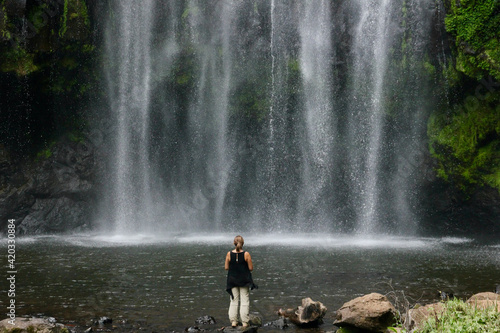 Standing in front of a waterfall