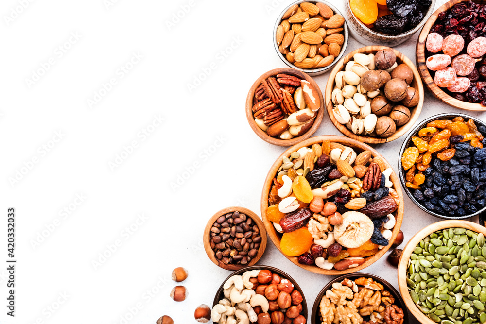 Nuts and dried fruits. Dried apricots, figs, prunes, raisins, cranberries, pecans, walnuts, pistachios, cashews, hazelnuts, almonds and other. Food background, top view Nuts and dried fruits. Dried apricots, figs, prunes, raisins, cranberries, pecans, walnuts, pistachios, cashews, hazelnuts, almonds and other. Food background, top view