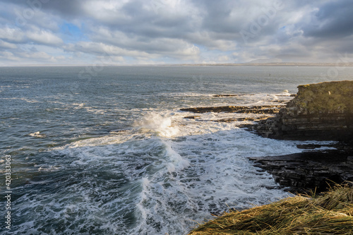View on the Atlantic ocean. Mullaghmore peninsula, county Sligo, Ireland. Blue water with waves, cloudy sky, nobody.