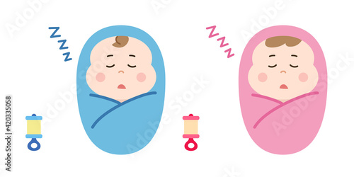 Sleeping newborn babies swaddled in a blanket with rattles.