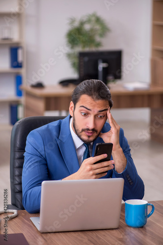 Young male employee working in the office