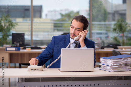 Young male employee working in the office