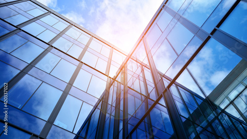 Modern office building with glass facade on a clear sky background. Transparent glass wall of office building.