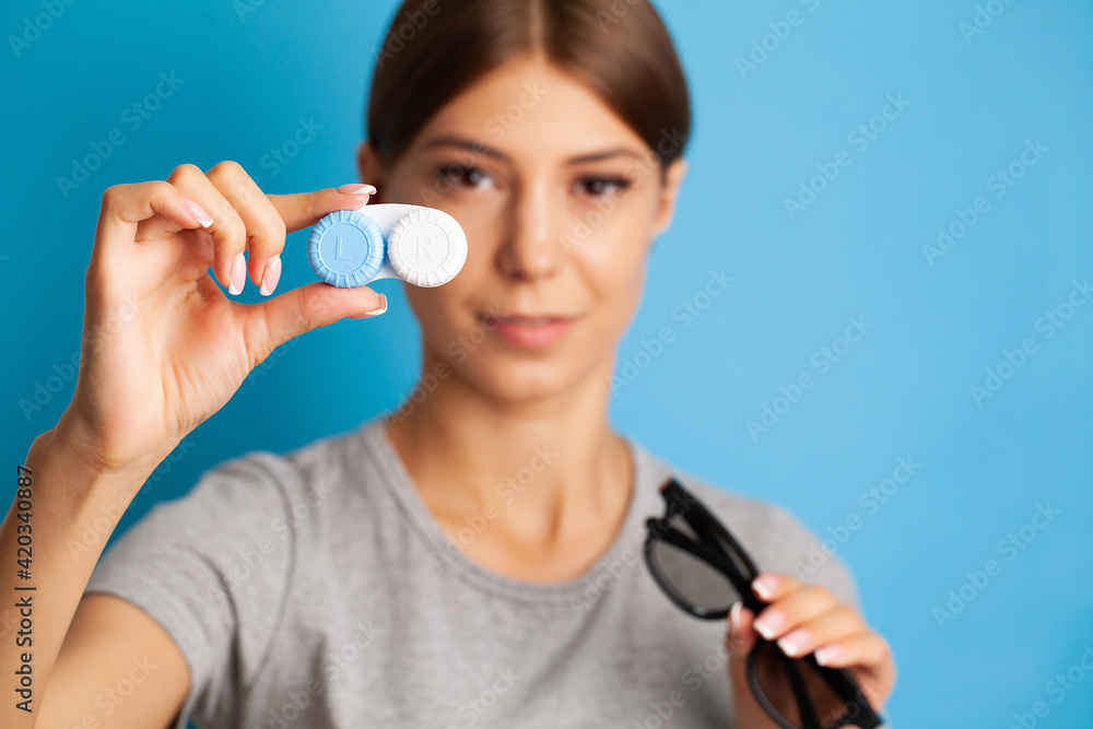 Close up of woman holding container with contact lenses Close up of woman holding container with contact lenses