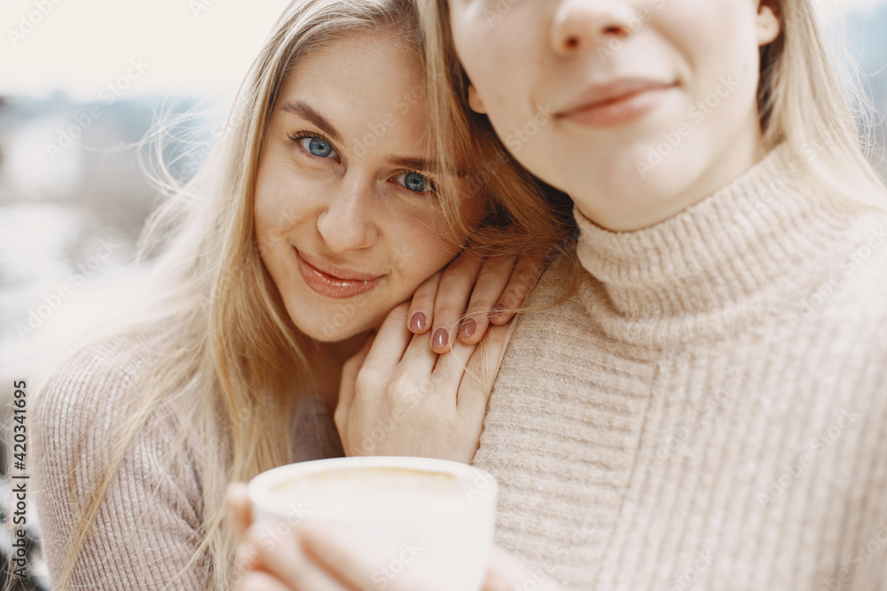 custom made wallpaper toronto digitalGirls in light clothes. Winter coffee on balcony. Happy women together.