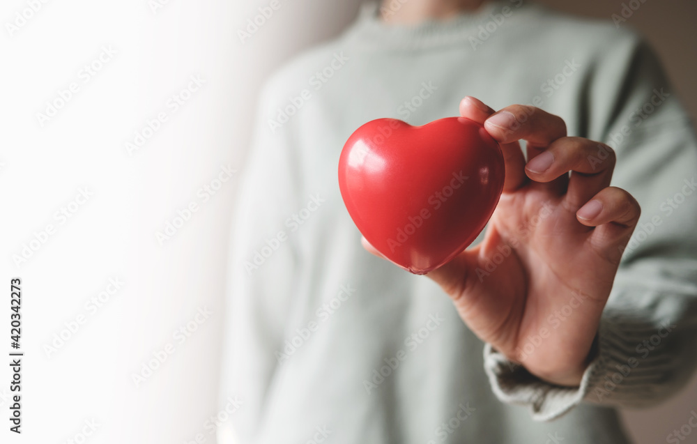 Red hearts with loving and caring adults. Symbol of support that expresses love valentine day and world heart day, heart health concept Red hearts with loving and caring adults. Symbol of support that expresses love valentine day and world heart day, heart health concept